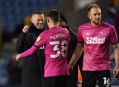 Derby County interim manager Wayne Rooney embraces Jason Knight.