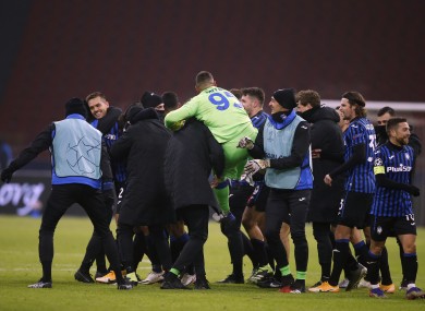 Atalanta players celebrate at the final whistle.
