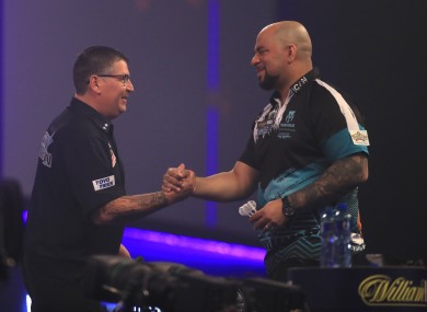Gary Anderson and Devon Petersen shake hands.