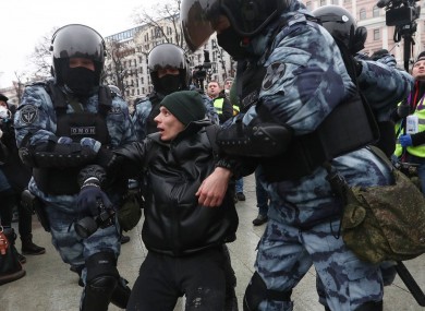 Police detain a man in Moscow during pro-Navalny protests yesterday.