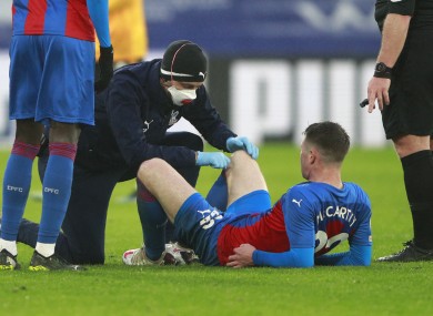 Crystal Palace's James McCarthy receives medical treatment.