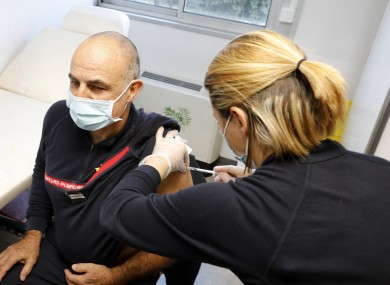 A firefighters gets vaccinated in Nimes, south of France, on 19 January.