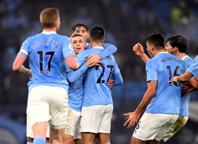 Phil Foden and his City team-mates enjoy the aftermath of his goal, although players have been asked to avoid hugs in their celebrations.