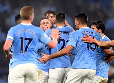The Manchester City players hug Phil Foden after his goal last night.