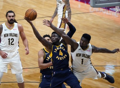 Indiana Pacers guard Victor Oladipo (4) and New Orleans Pelicans forward Zion Williamson (1) battle under the basket.
