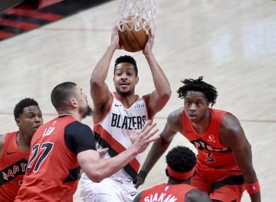 CJ McCollum rises to shoot over Raptors.