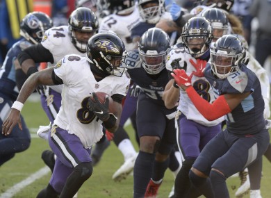 Lamar Jackson (8) scrambles against the Tennessee Titans.