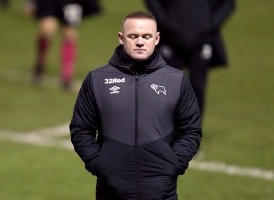 Interim Derby County manager Wayne Rooney looking dejected after his side's defeat to Sheffield Wednesday.