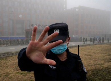 A security guard outside a lab in Wuhan that was visited by WHO officials last week