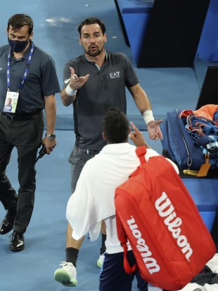 Italy's Salvatore Caruso, bottom, and compatriot Fabio Fognini argue after their second round match.