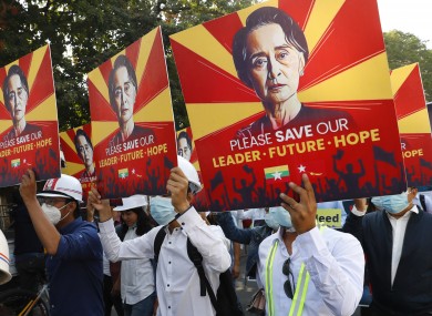 Engineers hold posters with an image of deposed Myanmar leader Aung San Suu Kyi as they hold an anti-coup protest march in Mandalay,