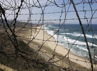 Barbed wire guards the coastal border of the separating South Korea with the demilitarized zone, looking northward towards North Korea, from the northern most point on the east coast of South Korea, near Goseong,
