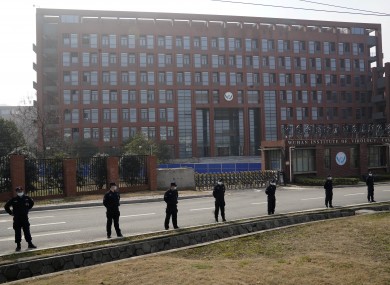 Security personnel gather near the entrance of the Wuhan Institute of Virology today.