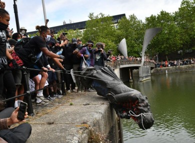 The statue of slaver Edward Colston being dumped onto ar river.