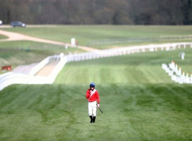 Jack Kennedy walks back along the course after falling from Envoi Allen.