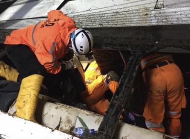 Rescuers search for survivors and victims inside the wreckage of a bus that plunged into a ravine in Sumedang West Java, Indonesia