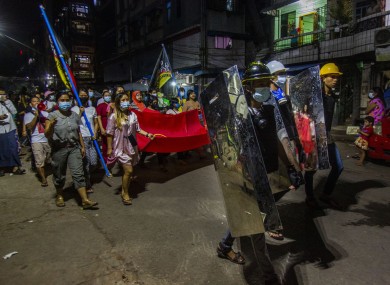 Residents march despite an overnight curfew in an anti-coup night rally in Yangon