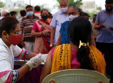 File photo a woman receiving a Covid-19 vaccine in India