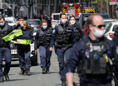 Police attend the scene of the shooting outside Henry Dupont hospital in Paris