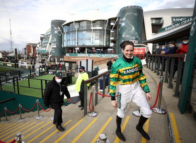 Rachael Blackmore walks back out of the winners enclosure after lifting the 2021 Grand National trophy.