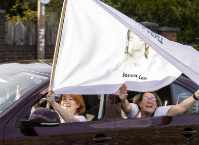 The families of the victims and supporters waving white flags with the words ‘innocent’ on them
