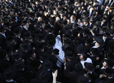 Mourners carry the body of Shragee Gestetner, a Canadian singer who died during Lag BaOmer celebrations at Mt Meron. 30 April.