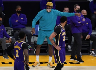 Injured Los Angeles Lakers forward LeBron James talks to his team-mates.