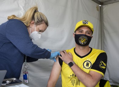 Columbus Crew SC supporter Steven Garver receives his J&J Covid vaccine from a Columbus Public Health nurse.