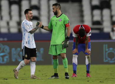 Lionel Messi and Chile goalkeeper Claudio Bravo shake hands.