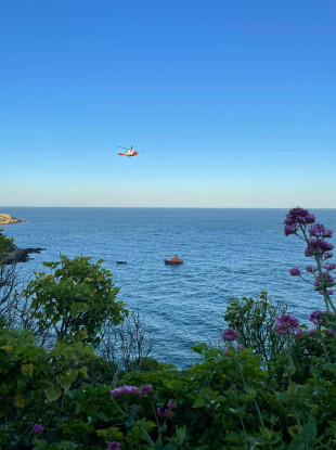 The emergency lifeboat and Rescue 116 helicopter on the coast line