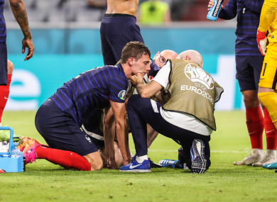 Benjamin Pavard receiving treatment from the medics.