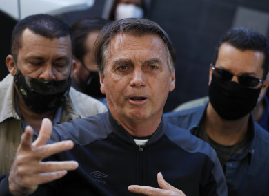 Jair Bolsonaro speaking to reporters after leaving hospital.