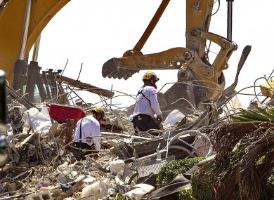 Rescue teams from Pennsylvania, search the rubble of the Champlain Towers in Surfside, Florida.