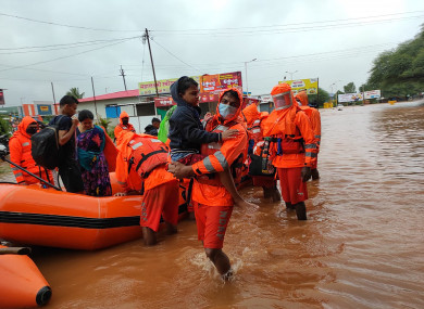 This photograph provided by India's National Disaster Response Force (NDRF) shows NDRF personnel rescuing residents in Chiplun area in the western Indian state of Maharashtra - 24 July