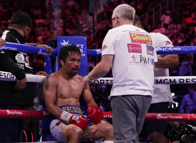 Trainer Freddie Roach speaks to Manny Pacquiao, of the Philippines, between rounds.
