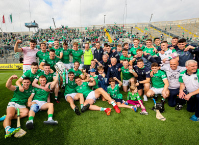 The Limerick staff and squad celebrate in front of Hill 16 with the Liam MacCarthy Cup.