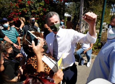 California Governor Gavin Newsom takes photos with supporters in Oakland.
