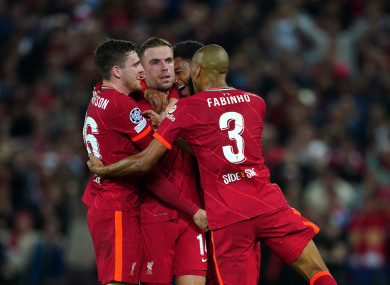 Liverpool's Jordan Henderson (centre) celebrates scoring.