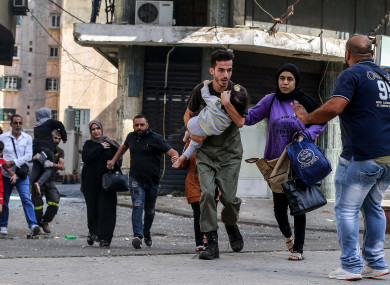 Civilians running for cover during the clashes today.