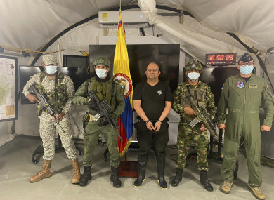 One of Colombia’s most wanted drug traffickers, Dairo Antonio Usuga, alias “Otoniel,” leader of the violent Clan del Golfo cartel, is presented to the media while flanked by armed soldiers at a military base in Necocli