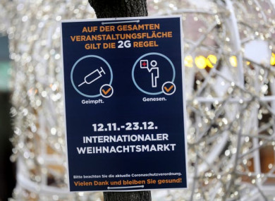 A sign detailing Covid-19 restrictions at the entrance to a Christmas market in Essen, Germany.