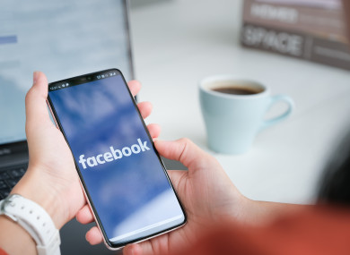 File photo of a phone showing the Facebook logo