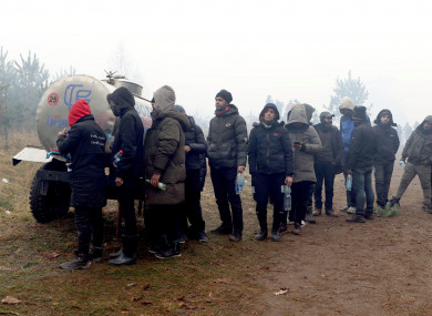 Migrants queue to get some water in a tent camp on the Belarusian-Polish border.