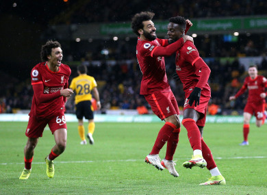 Divock Origi (right) celebrates with team-mates Trent Alexander-Arnold (left) and Mo Salah.