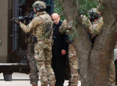 Authorities escort a hostage out of the Congregation Beth Israel synagogue.