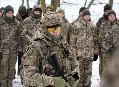 An instructor trains members of Ukraine's Territorial Defense Forces in a city park in Kyiv.