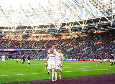 Jack Harrison celebrates after his third goal with Leeds United team-mates Lewis Bate and Dan James.
