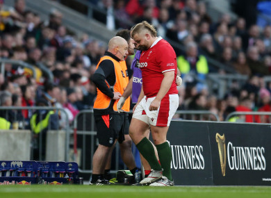 Tomas Francis leaves the pitch for a HIA during Wales Six Nations clash with England.