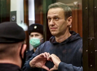 Alexei Navalny showing a heart symbol to his wife Yulia, after he was jailed for nearly three years in February 2021.
