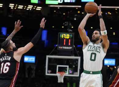 Boston Celtics forward Jayson Tatum (0) shoots over Miami Heat forward Caleb Martin (16) during the second half of Game 4 of the NBA basketball playoffs Eastern Conference finals.